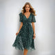Elegante v hals midi jurk met sierlijk silhouet